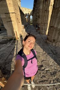 young woman posing for a selfie amidst ancient ruins