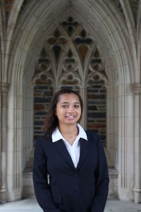 young woman in front of a gothic arch
