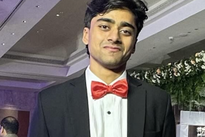 south asian man in suit and bowtie
