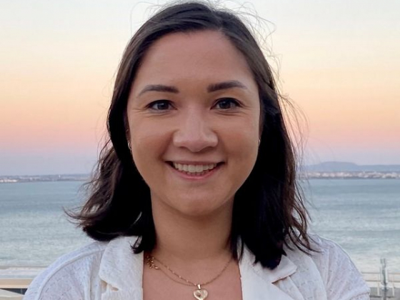 Female headshot with the ocean in the background