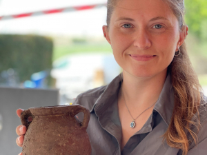 Dani with an intact vessel she uncovered from Vulci
