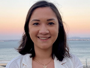 Female headshot with the ocean in the background