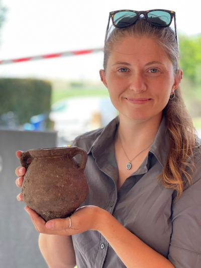 Dani with an intact vessel she uncovered from Vulci