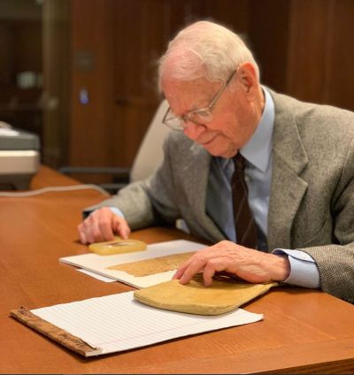 professor looks an ancient texts