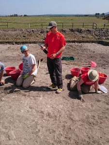 Katherine McCusker and Eleonora Delpozzo excavate while Dr. Maurizio Forte tests the new Smart Trowel. 